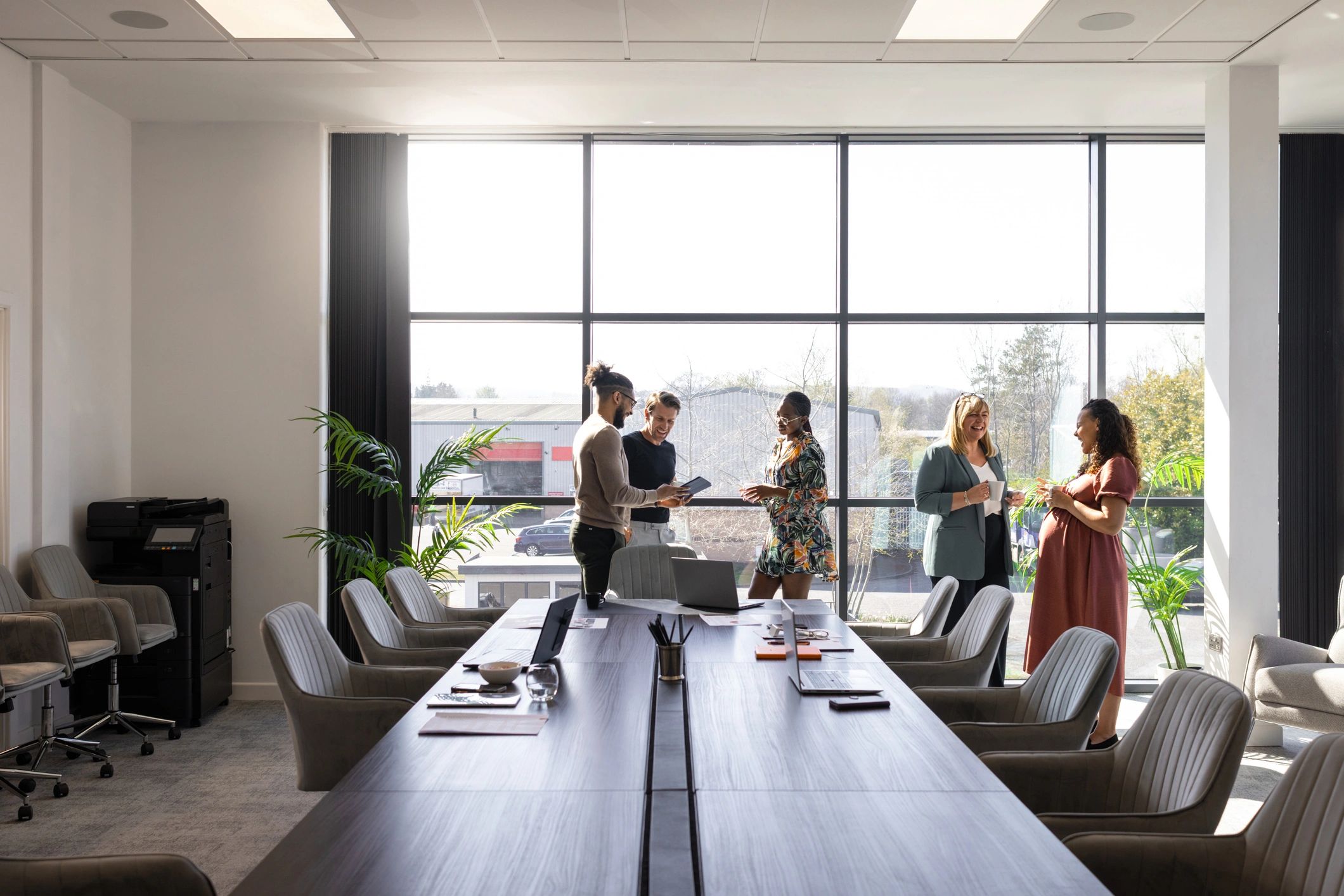 Colleagues discussing work in a conference room